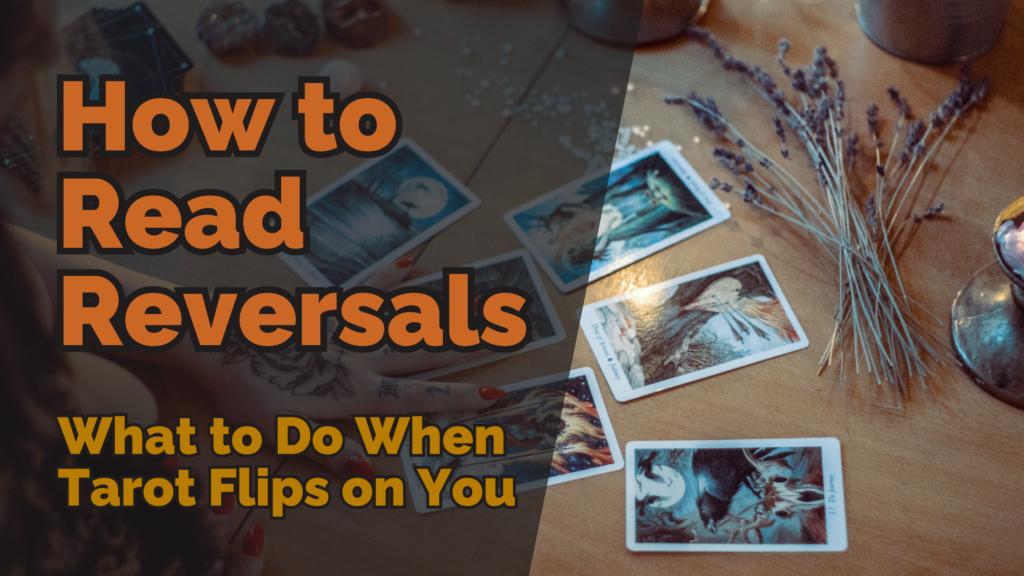 A tarot reading setup on a wooden table with reversed tarot cards scattered. A hand with tattooed fingers rests near the cards, and dried lavender lies beside them. The image has bold text overlay reading “how to read reversals: what to do when tarot flips on you. ”