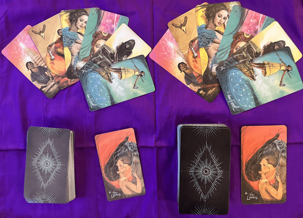 Two tarot decks side by side on a purple cloth. The left deck has muted colors and thinner cards, while the right deck has vibrant colors and thicker cards.