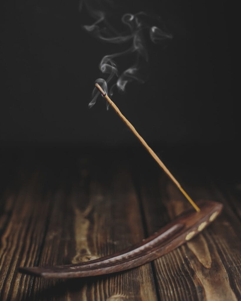 Brown wooden stick with black smoke