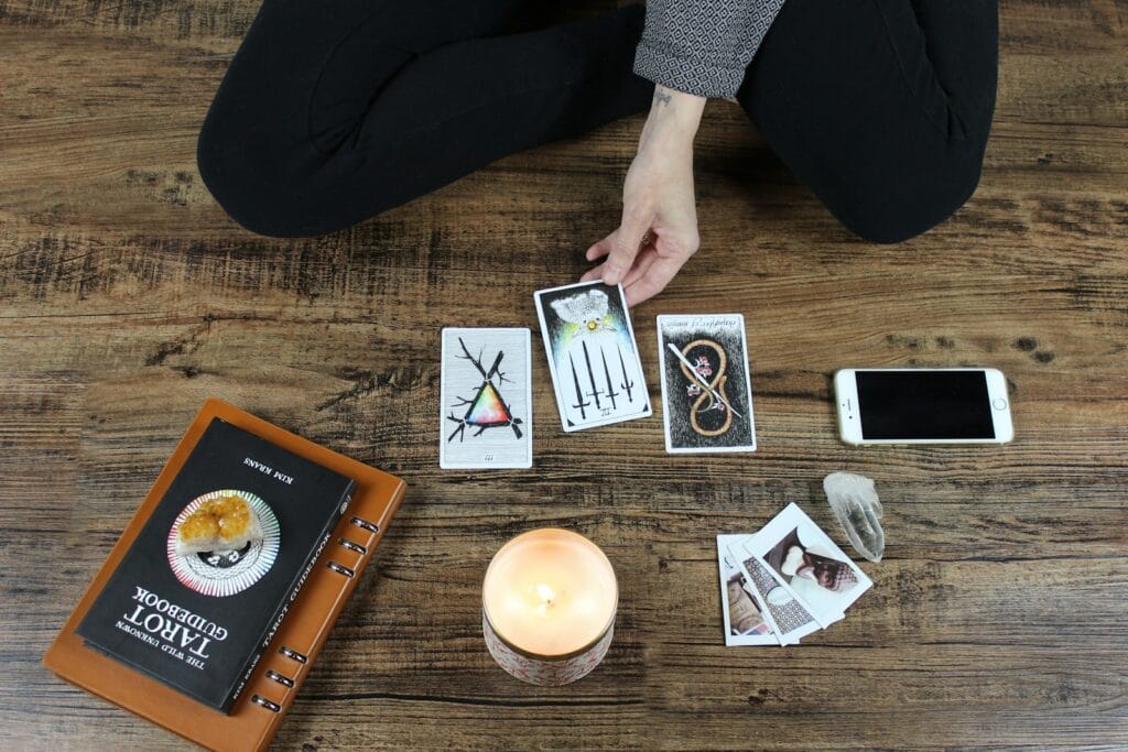 Person playing with tarrot cards