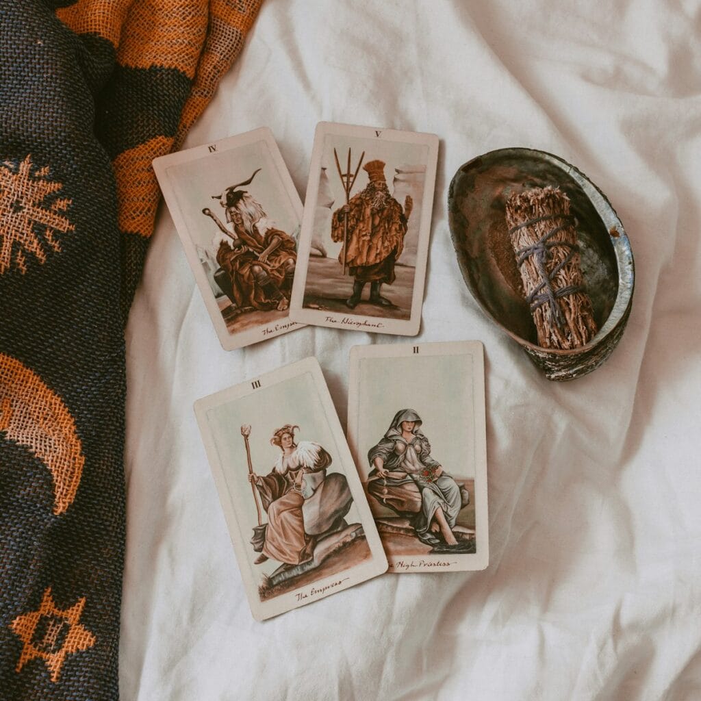 Tarot cards on a sheet with a shell