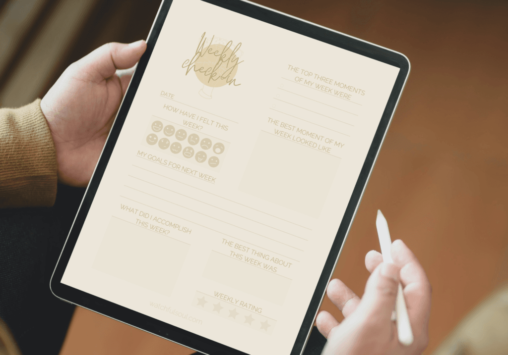 Close-up of hands holding a tablet showing the ‘weekly check-in’ journal, with prompts for tracking goals and reflecting on achievements.