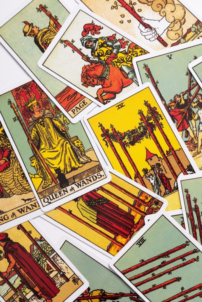 Cards from the rider-waite-smith tarot deck scatther on a white surface